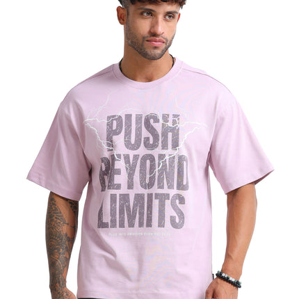 Man wearing a pink t-shirt with 'Push Beyond Limits' text on a white background
