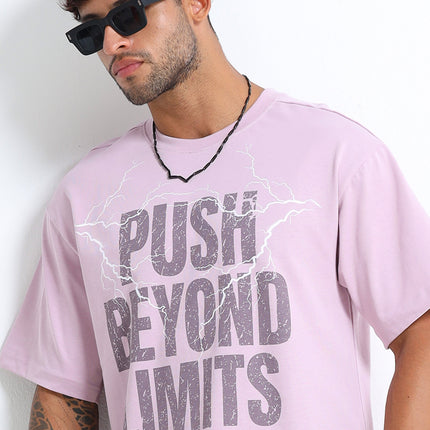 Man wearing a pink t-shirt with 'Push Beyond Limits' text against a white background