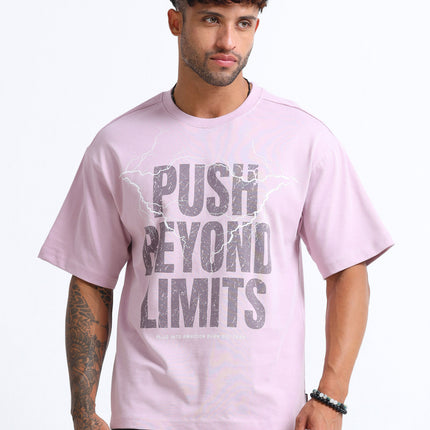 Man wearing a pink t-shirt with 'Push Beyond Limits' text on a white background