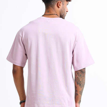 Person wearing a light pink t-shirt on a white background