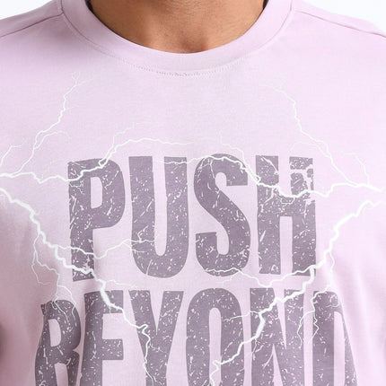 Person wearing a light purple t-shirt with 'Push Beyond Limits' text.
