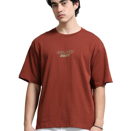 Person wearing a brown t-shirt with text on a white background