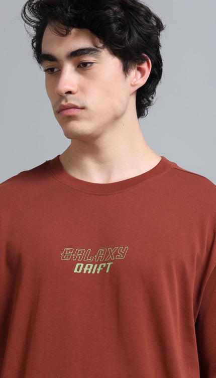 Man wearing a brown t-shirt with 'Galaxy Drift' text on a gray background