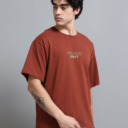 Man wearing a brown t-shirt with text on a gray background