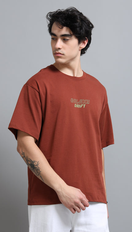 Man wearing a brown t-shirt with text on a gray background