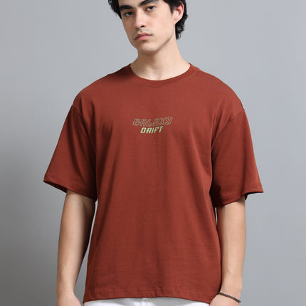Man wearing a brown t-shirt with text on a gray background