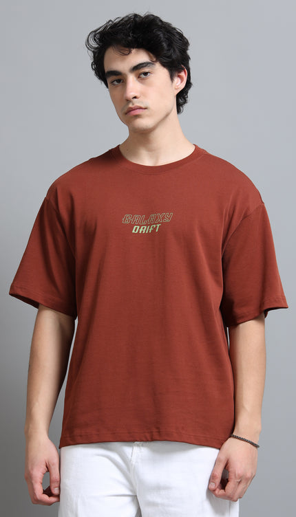 Man wearing a brown t-shirt with text on a gray background